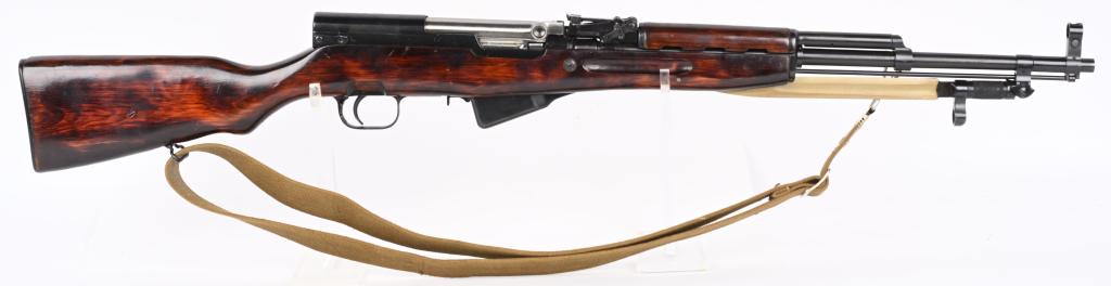 1954 SOVIET RUSSIAN TULA SKS SEMI AUTOMATIC RIFLE: SERIAL NUMBER: EM2494. BARREL: 20-1/2". CALIBER: 7.62X39. MANUFACTURED: 1954. Standard arsenal proofs on the chamber area. Tula star and "1954" marked on the dust cover. Stock has an arsenal cartouche
