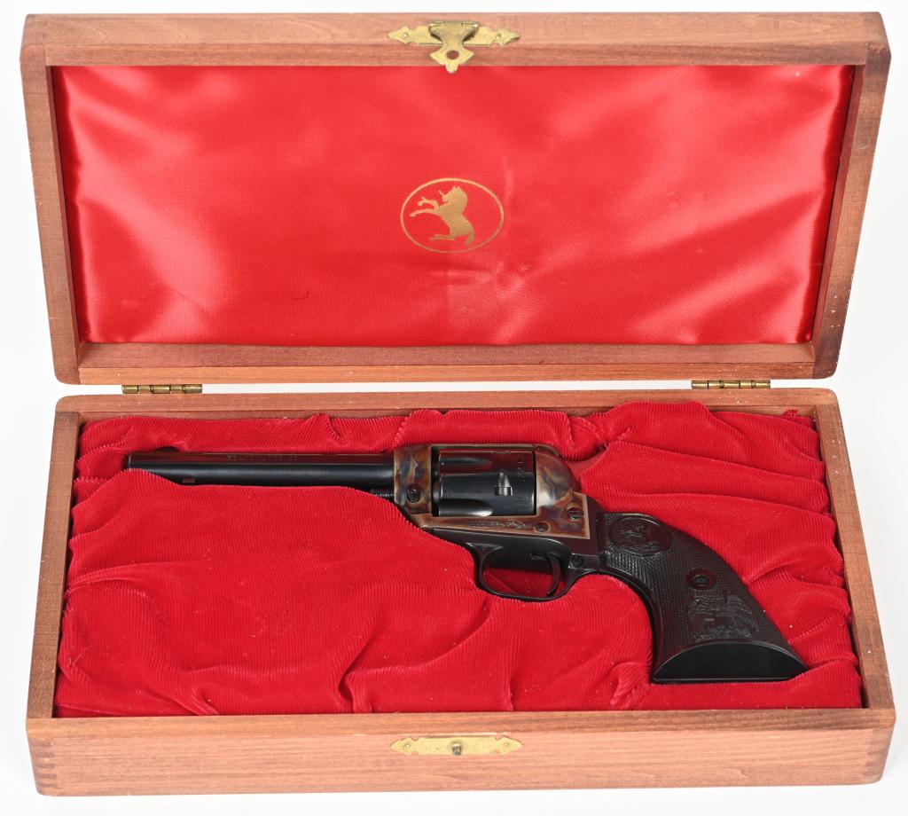 CASED COLT PEACEMAKER .22 REVOLVER: SERIAL G106314 3/4". CALIBER .22LR. MADE IN 1974. Standard blue and case color finish, eagle plastic grips, fixed sights, in Colt display wood box. Condition. Near new with light handling. Modern