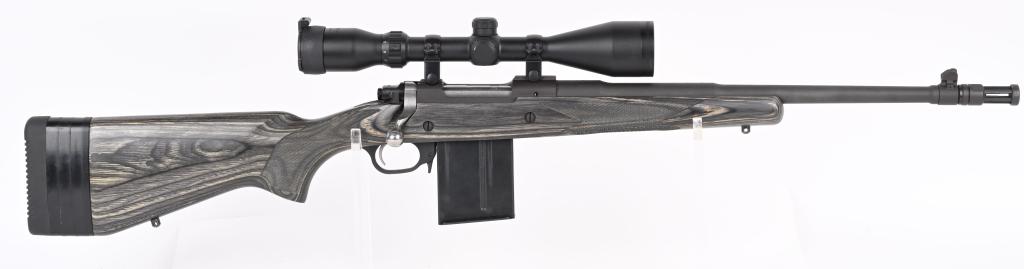RUGER GUNSITE SCOUT BOLT ACTION CARBINE: SERIAL NUMBER: 680-17444. BARREL: 19" (WITH FLASHHIDER). CALIBER: .308 WINCHESTER. MANUFACTURED: 2012. Standard markings and configuration. Factory full cage muzzle brake and blade front sight. Rear i