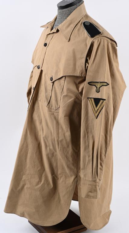 WWII NAZI WAFFEN SS TROPICAL TRANSPORT TUNIC WW2: Light-weight subtly ribbed tan cotton twill construction tropical "Sahariana" style field blouse features a vertical four button front closure with small fold back lapels and a lay down collar. The fi