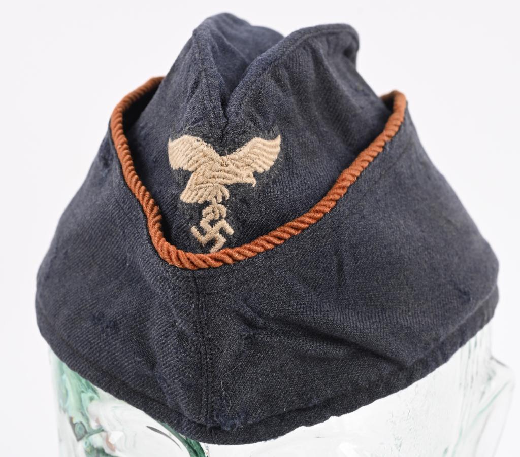 LUFTWAFFE SIGNALS FEMALE AUXILIARY OVERSEAS CAP: Nice quality, Luftwaffe blue/gray, wool/rayon blend construction cap features fold down side and back panels with gently sloping, downward scallops to the front and forward sides. The top edge of the