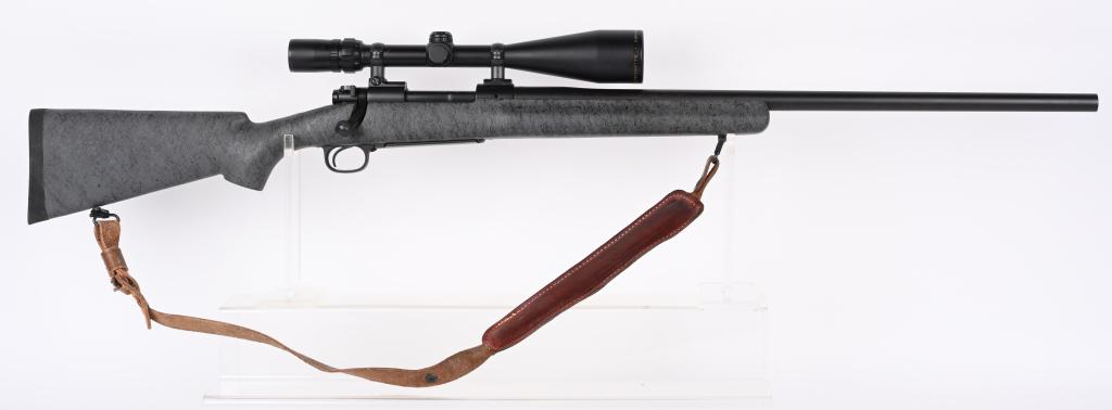 WINCHESTER MODEL 70 LAREDO 7MM REM MAG: SERIAL NUMBER: G183638. BARREL: 26". CALIBER: 7MM REM MAG. MANUFACTURED: 2000'S. Heavy barrel. Matte gay finish. Gray web stock. with black rubber Winchester butt plate. Includes attached Bausch & Lom