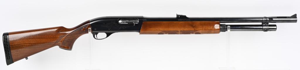 REMINGTON MODEL 1100 SEMI AUTO SLUG GUN: SERIAL M392851V. BARREL 22.5". GAUBE 12. CHAMBER 2 3/4" LOP 14". Barrel has "Turbo" vent with rifle sights, blue finish, press checkered high gloss pistol grip stock, Remington black recoil pad and ex