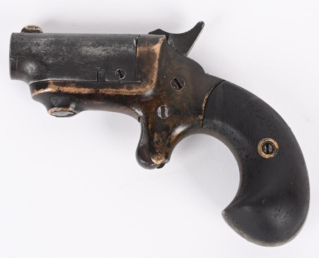 COLT THIRD MODEL DERINGER: SERIAL 1566. BARREL 1.5". CALIBER 41RF. MADE 1875-1912. Features brass frame with blue steel barrel and cylinder. Walnut bird head grips. Condition. Barrel period shortened from 2.5". Brass is dark pa