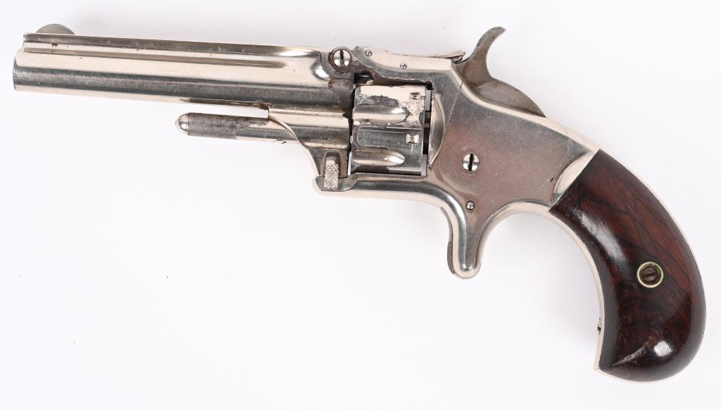 FINE SMITH & WESSON MOD. 1-3RD ISSUE REVOLVER: SERIAL 130123. BARREL 3 3/16. CALIBER .22 RF. MADE 1868-1881. Features nickel finish, bird head rosewood grips, 7-shot, spur trigger, barrel rib with address legend. Condition. Easily 98% with excepti