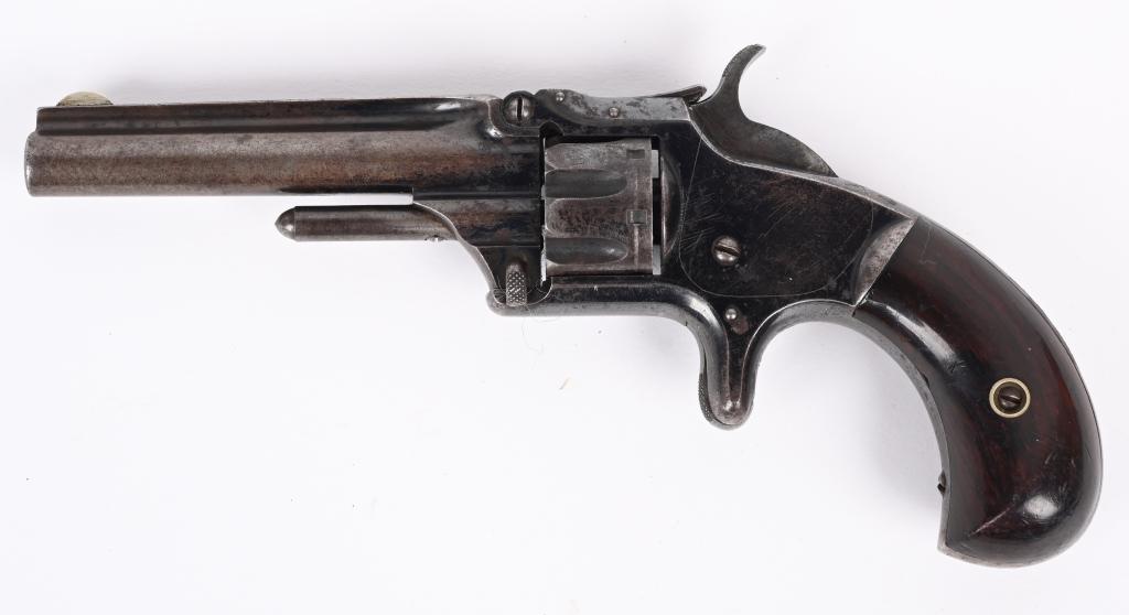 SMITH & WESSON MOD #1-3RD ISSUE: SERIAL 9780. BARREL 3". CALIBER .22RF. MADE 1868-1881. Features high polish blue finish, rosewood bird head grips, 7-shot, single action, spur trigger. Condition. Retains approximately 50% blue with b