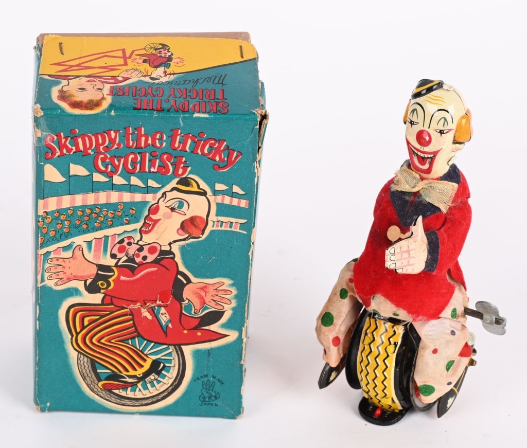 TPS JAPAN SKIPPY THE CLOWN CYCLIST w/ BOX: TPS Skippy the Clown Cyclist with the original box. The toy has bright colors, and worked when tested. The original colorful box is nice with wear. 6", Excellent