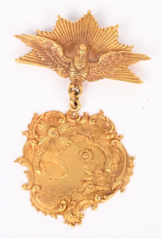 HUGUENOT SOCIETY OF AMERICA MEDAL BY TIFFANY: Marked TIFFANY 14K verso. Dimensions: (Overall) H 4" x W 2" Condition: Minor age discoloration to ribbon. Tarnish to silver. Engraved to the reverse " The Huguenot Society Of America No. 109 ALFRED HO