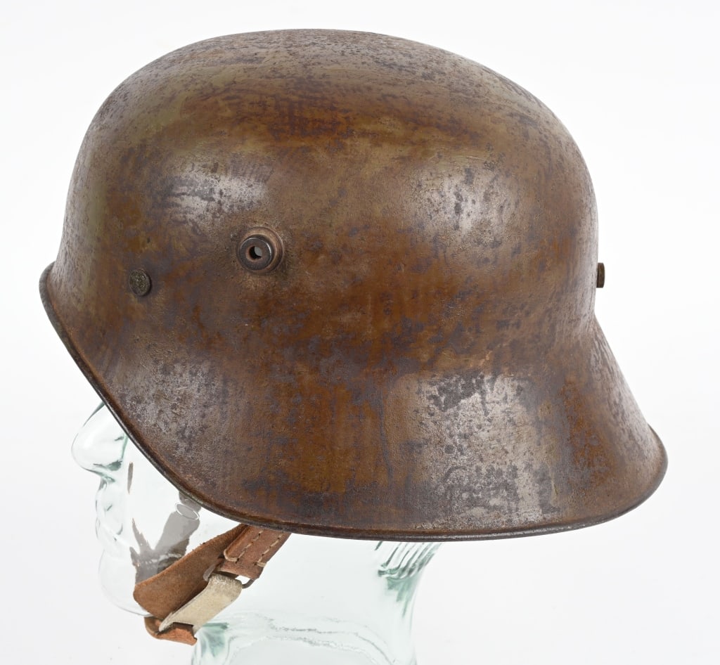 WWI TURKISH M18 COMBAT VISORLESS HELMET W LINER: Probably the most rare of all WWI Steel Helmets, only 5,400 of these were manufactured in Germany for shipment to their ally Turkey. Essentially a German M-1918 Helmet with the peak removed, this helm