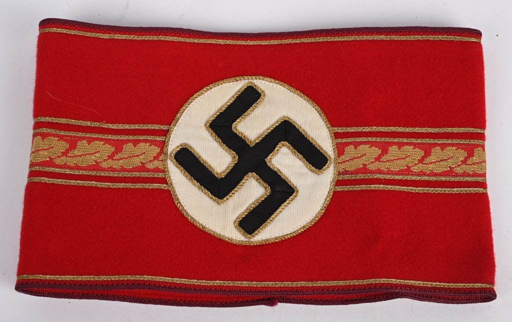 WWII NAZI GERMAN GAU LEVEL LEADER'S ARMBAND W TAG: Nice quality, multi-piece wool and rayon construction Gau level, administrative armband. Roughly 13cm tall, 52cm long, armband features a heavy red wool base with central white rayon circular field wi