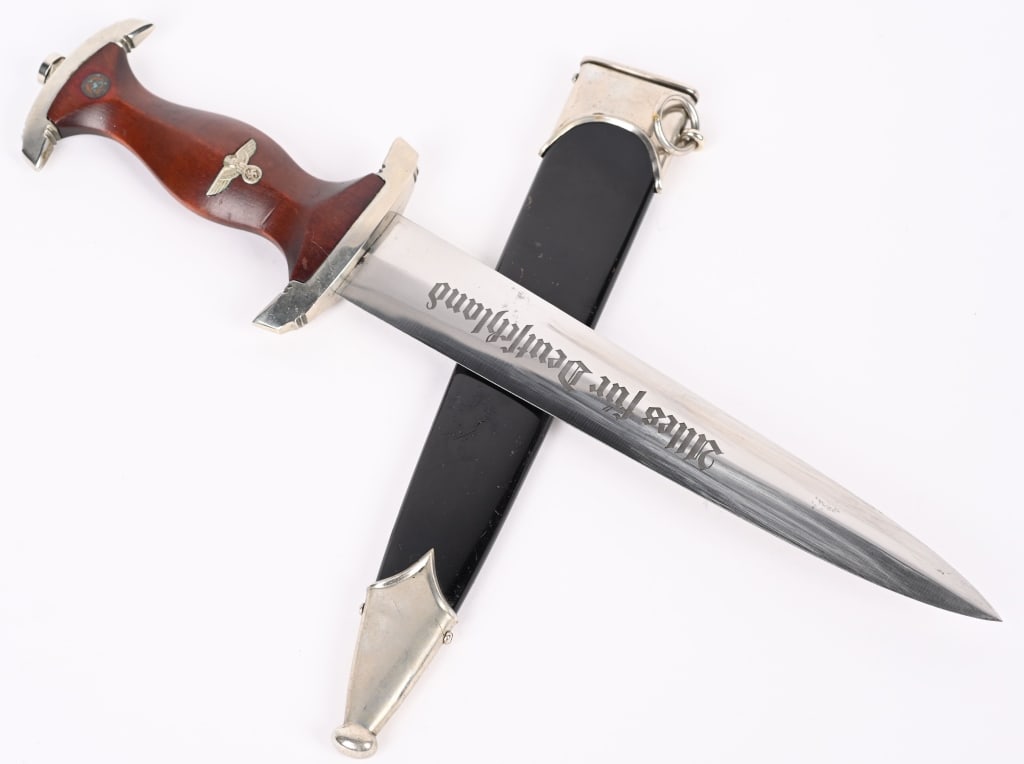 WWII NAZI GERMAN NSKK DAGGER by EICKHORN WW2: German World War II NSKK Motor Korps EM Dagger & Scabbard. Measures 14 3/4" long overall. The front of the etched steel blade reads ëAlles fur Deutschlandí (Everything for Germany). The reve