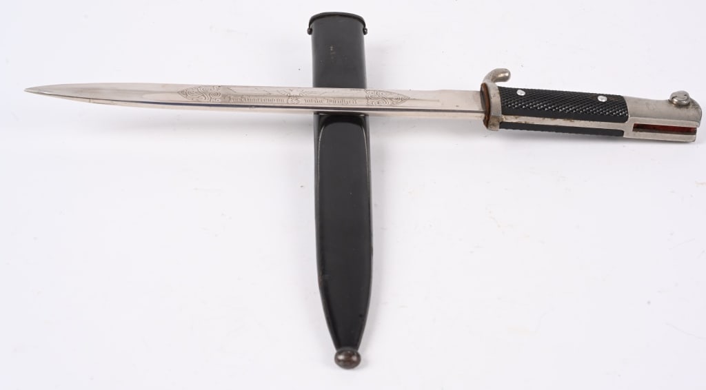 WWII NAZI GERMAN SINGLE ENGRAVED BAYONET E. PACK: Roughly a 10 inch long nickel/silver plated drop forged steel construction blade with deep narrow fullers to each side a top edge swedge to the forward tip and an acid etched design to the obverse. Bl