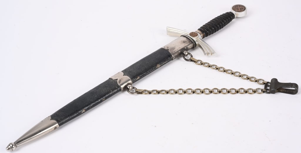 WWII NAZI GERMAN 1ST MOD. LUFTWAFFE DAGGER WW2: 1st Model (1934/35) Luftwaffe dagger and hanger with aluminum crossguard and pommel with nickel silver scabbard fittings. Blade marked Emil Voos. Leather grip has minor wear with all wire wrap tight. 