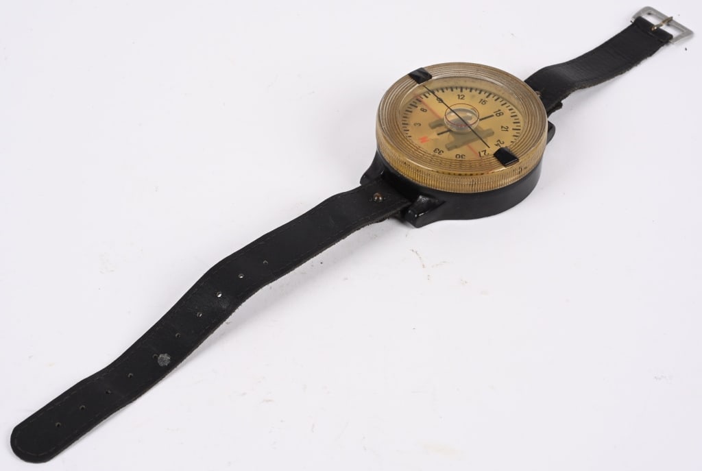 WWII NAZI GERMAN LUFTWAFFE FLIGHT WRIST COMPASS: Roughly, 2 3/8" diameter and 7/8" thick, molded, black, white and clear Bakelite construction, clear, liquid filled, AK39 wrist compass with a blackened leather wrist strap and alloy fittings. The com