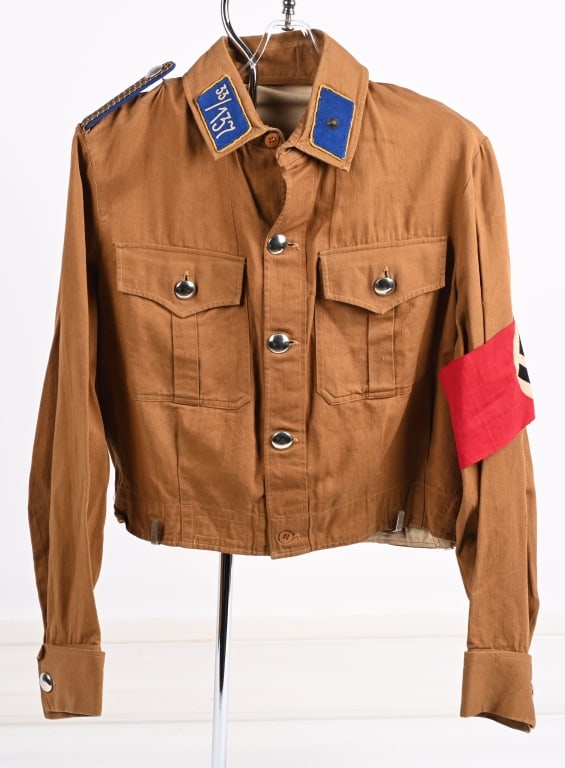 WWII NAZI GERMAN HANSA GROUP MEDICAL BROWN SHIRT: Light tan cotton twill construction shirt with a five button front closure. Shirt features two pleated, patch, breast pockets with scalloped flaps with removable buttons. Sleeves have five tapering da