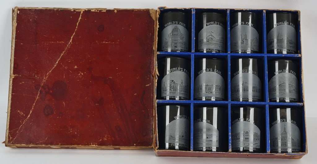 1893 World's Fair 12 ETCHED TUMBLERS IN ORIG BOX: Group of twelve (12) etched glass tumblers from the 1893 Columbian Exposition in their original fitted box. Each tumbler pictures a World's Fair building. Box dimensions are 11 1/2" x 11 3/4" . The tu