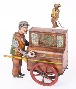 DISTLER TIN WINDUP ORGAN GRINDER & MONKEY: German tin windup Organ Grinder and Monkey. Windup works. Toy has a nice design. Wheels are loose and Monkey has been replaced. 8 1/2" Very Good-Excellent