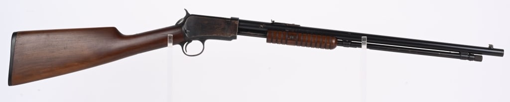 FINE WINCHESTER MODEL 1906 SLIDE ACTION 22 RIFLE: SERIAL 825324. BARREL 20". CALIBER .22RF. Late post 1934 gun made up from inventory parts before the war. Features round barrel, tube magazine, take down, blue finish, walnut stocks, sporting sights. 