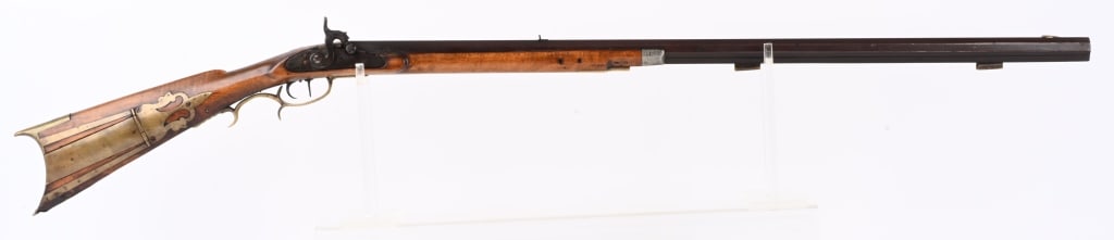 UNMARKED HALF STOCK PLAINS RIFLE: BARREL 34". CALIBER 32. Full octagon barrel, double trigger, leaf rear sight, half stock, pewter tip, brass furniture with patch box. No rod. Hammer does not cock. Condition. All brown patina. ill fit