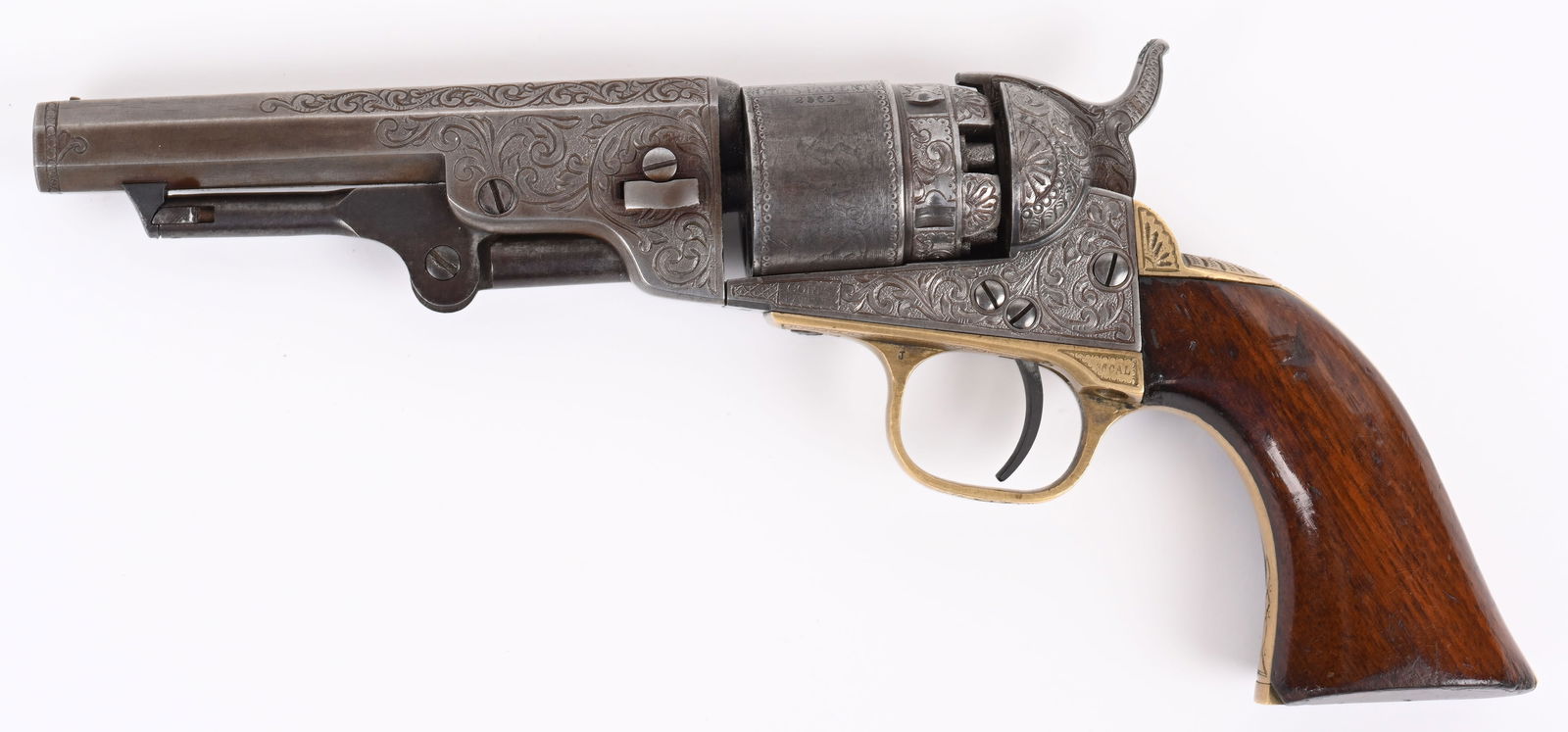 ENGRAVED COLT MODEL 1862 POCKET NAVY: SERIAL 2562. BARREL 4.5". CALIBER .36. MADE IN 1861. Gun has matching numbers on frame, barrel, trigger guard, back strap, cylinder and wedge. Cylinder has stage coach scene which is 75% intact. Gun h