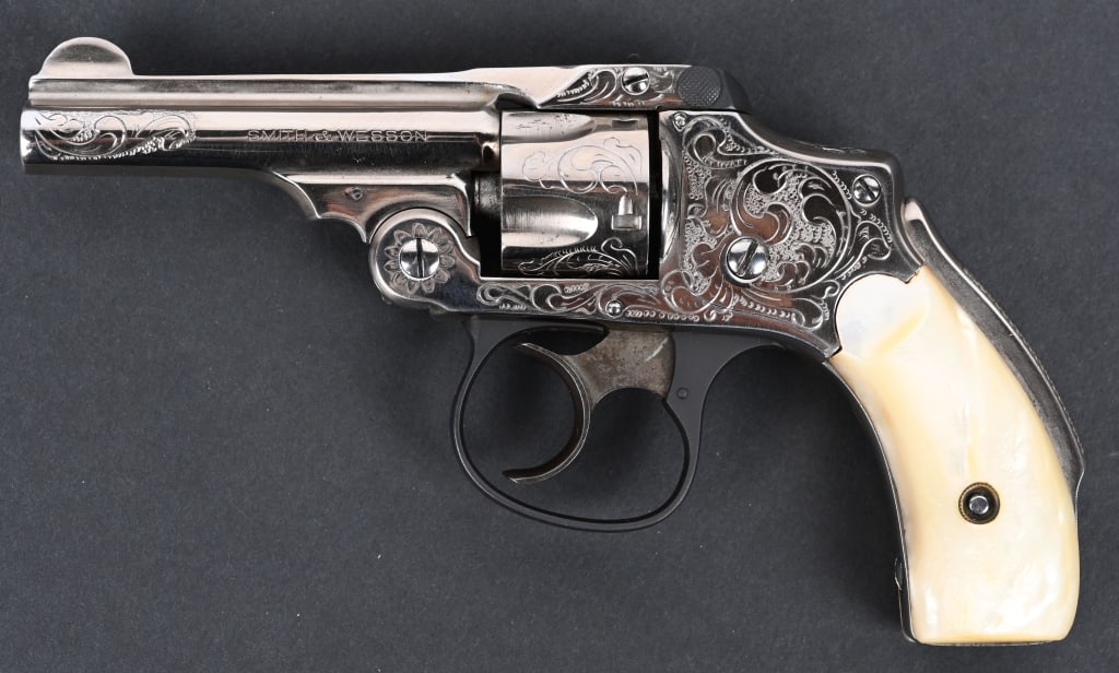 ENGRAVED SMITH & WESSON .32 NEW DEPARTURE REVOLVER: SERIAL NUMBER 222688 BARREL 3-1/2" CALIBER .32 SMITH & WESSON MANUFACTURED EARLY 1900's. Nickel finished top break Smith & Wesson New Departure model with Squeezer type grips safety. 2 piece mother of