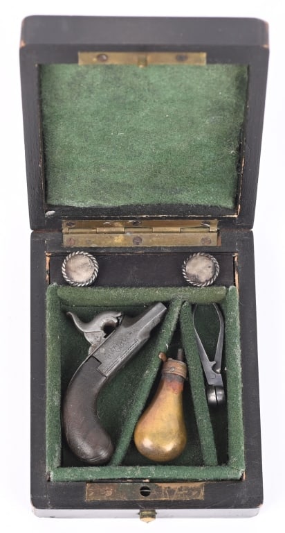 PUBLISHED ANTIQUE CASED MINIATURE MUFF PISTOL: Featured on pages 52-53 of Winants "FIREARMS CURIOUSA" book is this set of diminutive percussion muff pistol with matching mechanical flask , mold and cap and ball cons. Housed in a crushed wool parti