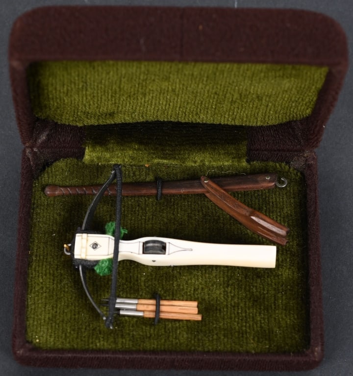 MINIATURE EARLY CROSSBOW BY ALLAN BILBOW: Hand crafted by Miniature arms maker Allan Bilbow, miniature crossbow with faux ivory stock, steel bow and comes with 3 bolts and mechanical cocking device. All cased in its fitted display case. The b