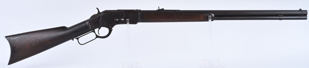 WINCHESTER MODEL 1873 RIFLE: SERIAL 243142. BARREL 24". CALIBER 38-40. MADE IN 1887. Standard rifle with full octagon barrel, full magazine, original sporting sights, walnut stocks with trap door butt plate. Condition. Untouched 