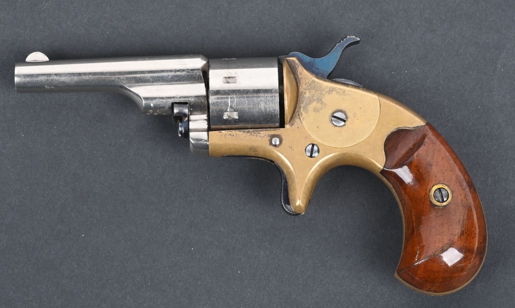 COLT OPEN TOP POCKET REVOLVER: SERIAL 74730. BARREL 2 3/8". CALIBER 22RF. MADE 1871-1877. Nickel plated barrel & cylinder, brass frame, walnut bird head grips, spur trigger, 7-shot single action. Condition. 98% nickel on barrel & c
