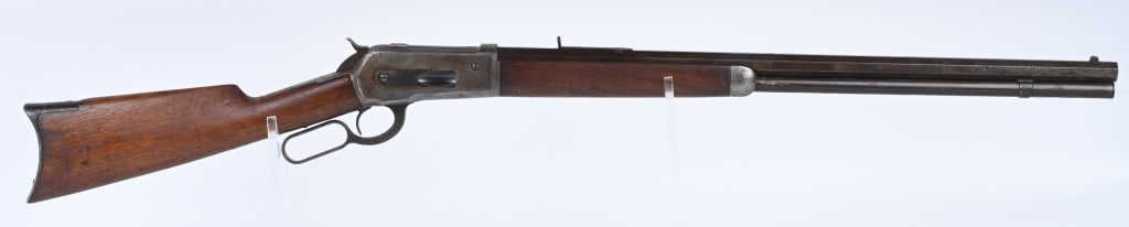 NEAR RELIC WINCHESTER MODEL 1886 RIFLE: SERIAL 87214. BARREL 26". CALIBER 40-65. MADE IN 1894. Full octagon and tube, original sporting sights, walnut stocks, rifle butt plate. There is a ranch brand on left side of stock. This rifle is com
