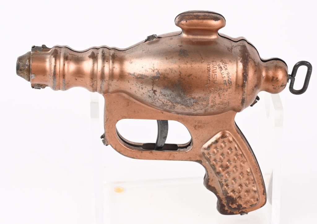 DAISY BUCK ROGERS LIQUID HELIUM WATER PISTOL: All original in unusual copper finish. Doesn't seem to be working. 7 1/2" Very Good