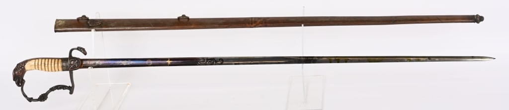 PRE CIVIL WAR EAGLE HEAD POMMEL SWORD W/ SCABBARD: Pre Civil War brass hilt eagle head pommel sword with engraved blade with blue panels. The flat embellished knuckle bow is typical of this time period. The languets on the obverse side has a large sca