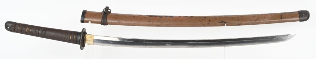 JAPANESE SHIN GUNTO TYPE 94 KATANA w/ SAYA: The katana has a 25" cutting edge. The blade is bright with minor abrasions. It has a visible hamon on both sides. The 2 hole tang is signed on both sides. The tsuka mounts and tsuba are black painted