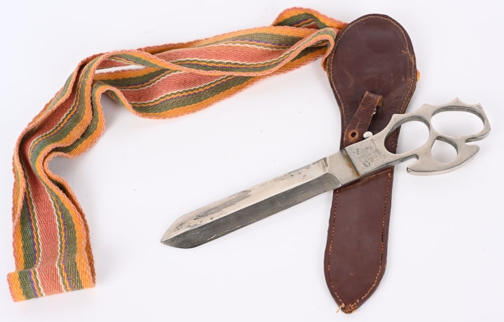 JODHPUR CITY PRINCESS WEDDING KNUCKLE KNIFE 1950: A Jodhpur City Volunteer Corps knuckle duster knife, blade length 15.5cm, detailed to hilt 'Auspicious Wedding Princess Jodhpur April 22nd 1950', with leather scabbard with fabric suspension. Excellen
