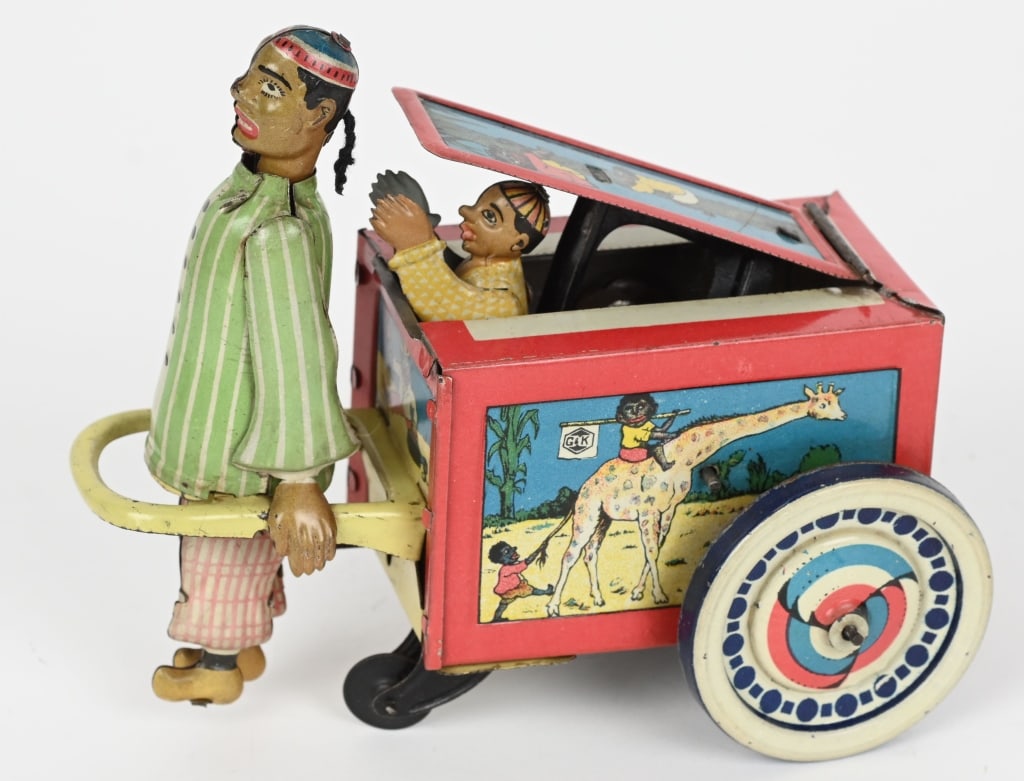 G&K TIN WINDUP COOLIE WAGON: German tin windup Coolie Wagon. All original with great graphics. Chinaman pulls the cart along and Boy pops out of the cart. Windup works and the toy has great actions. 6 1/2" Excellent