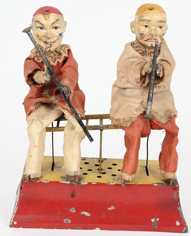 GUNTHERMANN CLOWN BASSOON & VIOLIN PLAYERS: Scarce oversized German hand painted with windup Clowns playing bassoon and clarinet. All original and in wonderful condition. The windup works and both figures move and play instruments. The music st