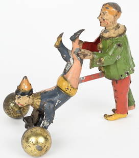 HANS EBERL PERFORMING WHEELBARROW CLOWNS: German hand painted tin windup Performing Wheelbarrow Clowns. All original oversize pair of Clowns. Windup works and Standing Clown pushes Clown holding bar with balls. Very unique toy. 8" Excellent