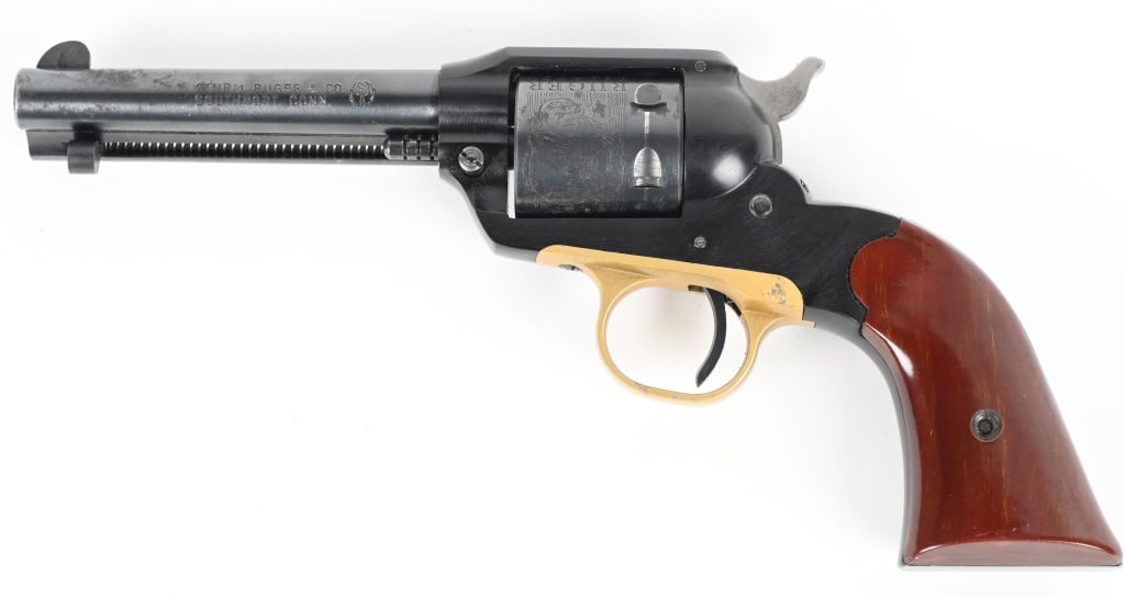 SECOND YEAR RUGER BEARCAT SINGLE ACTION REVOLVER: SERIAL NUMBER: K661. BARREL: 4". CALIBER: .22LR. MANUFACTURED: 1959. Standard markings and factory engraved six shot cylinder. Simple sights, blued finish, brass trigger guard and brown plastic grips.
