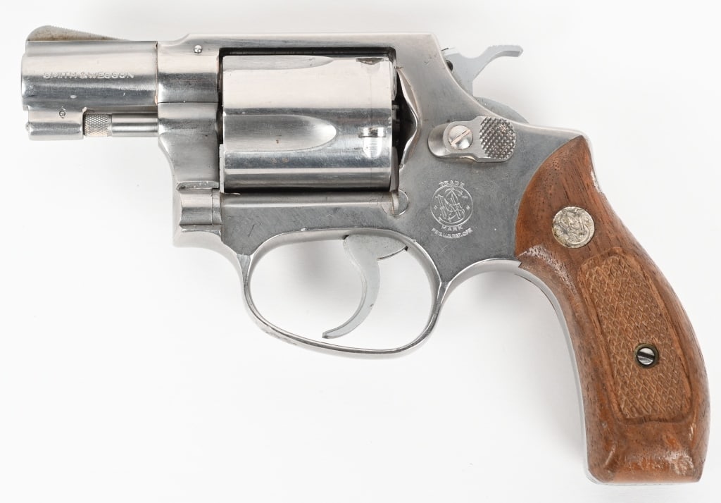 SMITH & WESSON MODEL 60 STAINLESS REVOLVER: SERIAL R231025. BARREL 1 7/8". CALIBER 38 SPECIAL. Stainless J-frame, round butt, 3-screw, 5-shot, double action, pinned barrel, checkered grips. Condition. Cylinder has no burn and appears unfired wi