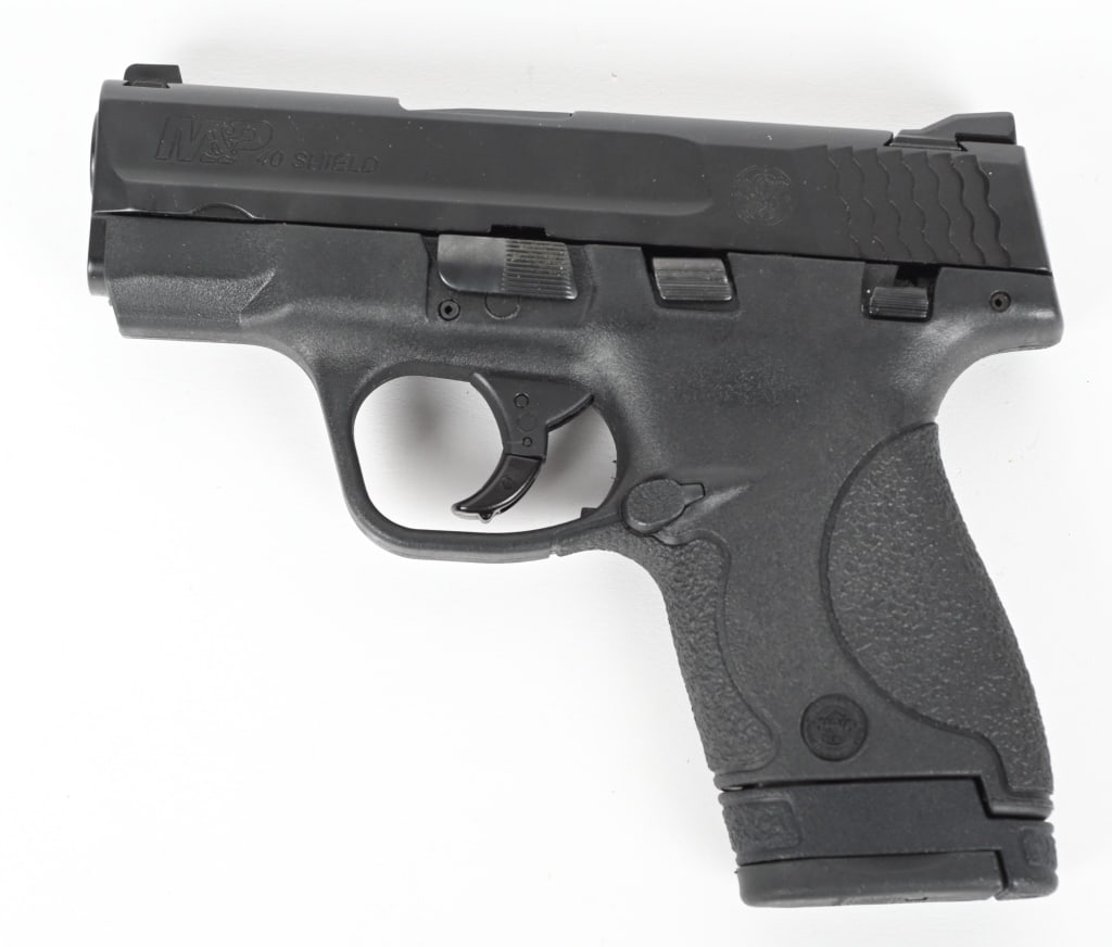 SMITH & WESSON M&P 40 SHIELD SEMI AUTO PISTOL: SERIAL NUMBER: HKZ5839. BARREL: 3". CALIBER: .40 S&W. MANUFACTURED: 2010S. Standard markings and features. Factory 3-dot sights, matte black slide and polymer frame. Includes factory seven round metal