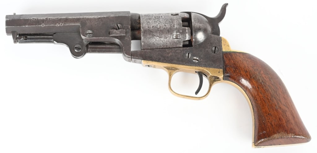 COLT MODEL 1849 PERCUSSION REVOLVER: SERIAL 69316. BARREL 4". CALIBER .31. MADE IN 1853 W/NY ADDRESS. Features an octagon barrel, cylinder with stage coach roll die, brass guards, one piece varnished walnut grips. All matching numbers in