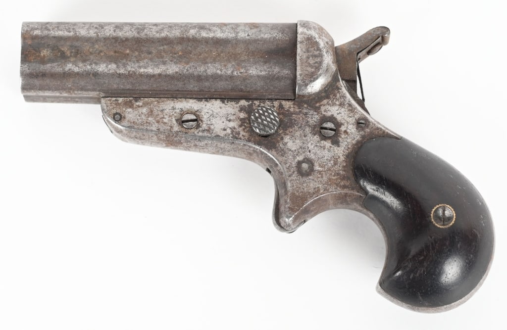 C.SHARPS 4-BARREL DERINGER: SERIAL 8615. BARREL 2.5". CALIBER 32. C. Sharps stamp on right side. Spur trigger, 4 shot, bird head walnut stocks. Condition. No original finish. Firing pin rotates correctly. Bores are rough. ANTIQU