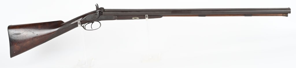 JOS. JAKOB PHIL. PERCUSSION SXS HAMMER SHOTGUN: BARRELS 30". GAUGE 12 GA. Maker name on both side locks, checkered one piece walnut stock, double triggers, wooden ramrod. Condition. Smooth brown patina, wood is excellent with sharp checkering, fine
