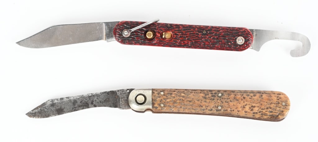 TWO EARLY AUTOMATIC POCKET KNIVES: A. CAMILLUS NEW YORK. Blade is maker stamped and has lock and release button, stag handle, separate hook tool, lanyard, 7.5" opened. Excellent. B. Press button, US pat. applied for, single blade, stag