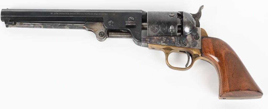 NAVY ARMS COLT COPY 1851 NAVY REVOLVER: SERIAL 115153. BARREL 7.5". CALIBER 36. Standard Navy with octagon barrel, naval scene on cylinder one piece walnut grips, brass straps, blue and case color finish. Condition. Has been used , brass is