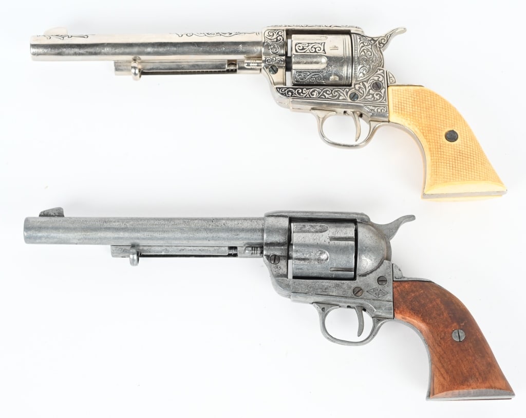TWO FULL SIZE COLT SAA NON FIRING REVOLVERS: if you collect vintage holsters, these would be perfect for your display. Both are 7.5" barrels. One is nickel finish, engraved, with faux checkered Ivory grips. The other is all patina with wood grip