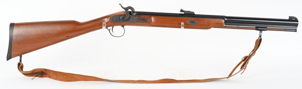 THOMPSON CENTER WHITE MOUNTAIN CARBINE: SERIAL 59543. BARREL 22". CALIBER 54 PERCUSSION. Blue octagon to round barrel, target rear sight, case color lock, walnut half stock, solid black rubber pad, sling. Condition. Metal is 98% with light