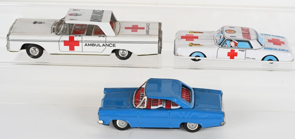 3- JAPAN TIN FRICTION CARS: Includes 2 Ambulances and Ford Coupe. All work. Largest 9" Excellent
