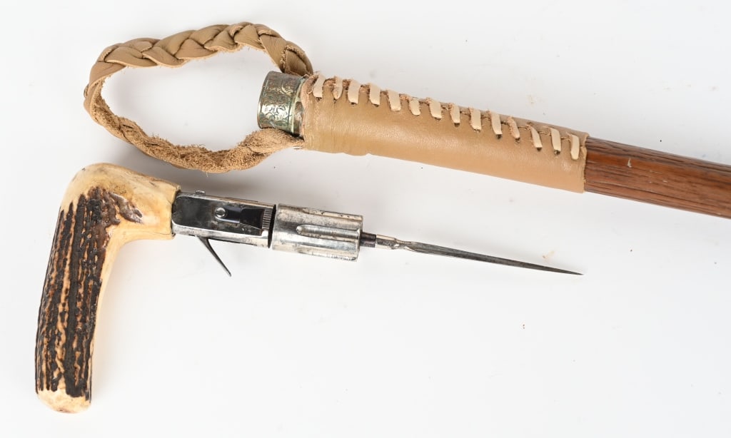 19TH CENTURY FRENCH PEPPERBOX CANE GUN: SERIAL NUMBER 95, BARREL 1 5/8", CALIBER 5MM, Scarce cane gun with 6 shot revolver pepperbox barrels and 4" spike blade. The grip is stag horn. The wood shaft is 33 1/2" and there is a leather carryin