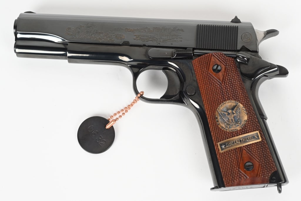 COLT MODEL 1911 WW1 COMMEMORATIVE CHATEAU THIERRY: SERIAL NUMBER: 3559-CT. BARREL: 5". CALIBER: .45 ACP. MANUFACTURED: 1967. Battle of Chateau Thierry gun, with battle scene engraved on the left side of the slide and "1917/ WORLD WAR 1 COMMEMORATIVE 1